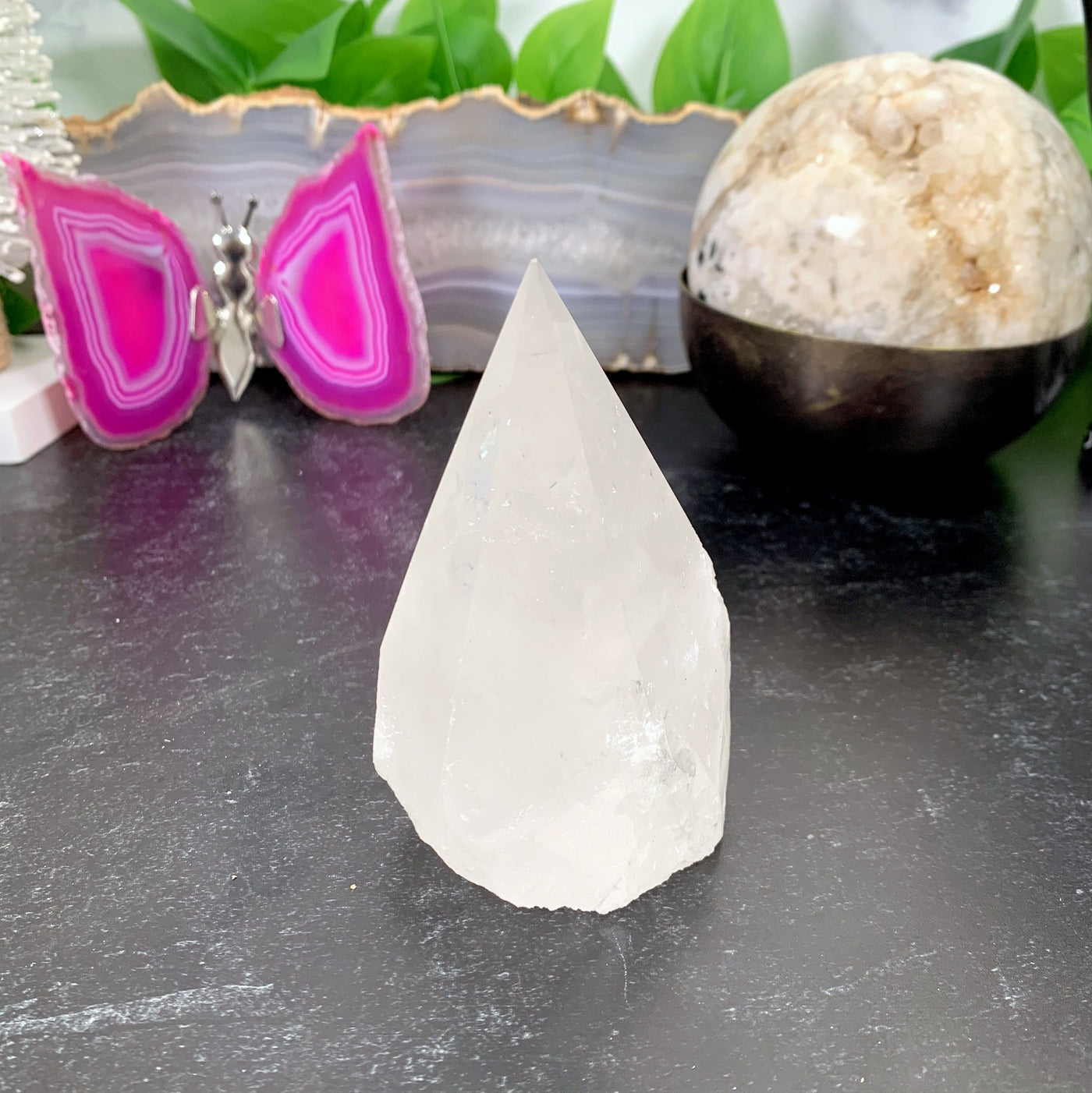 Crystal Quartz Point  with decorations in the background