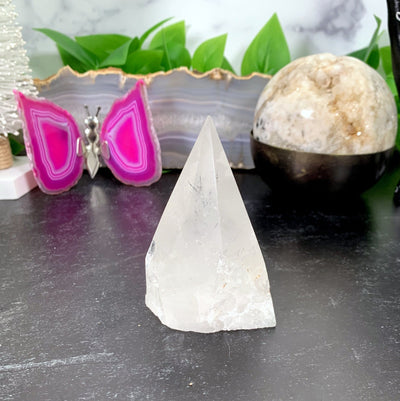 Crystal Quartz Point  with decorations in the background