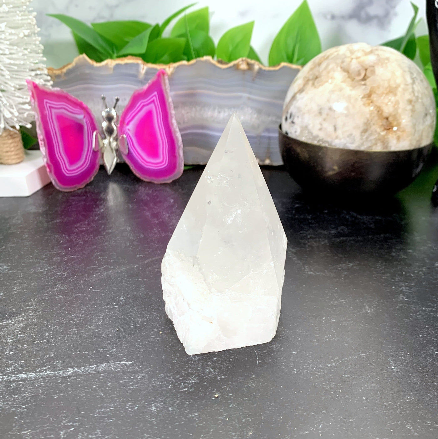 Crystal Quartz Point  with decorations in the background