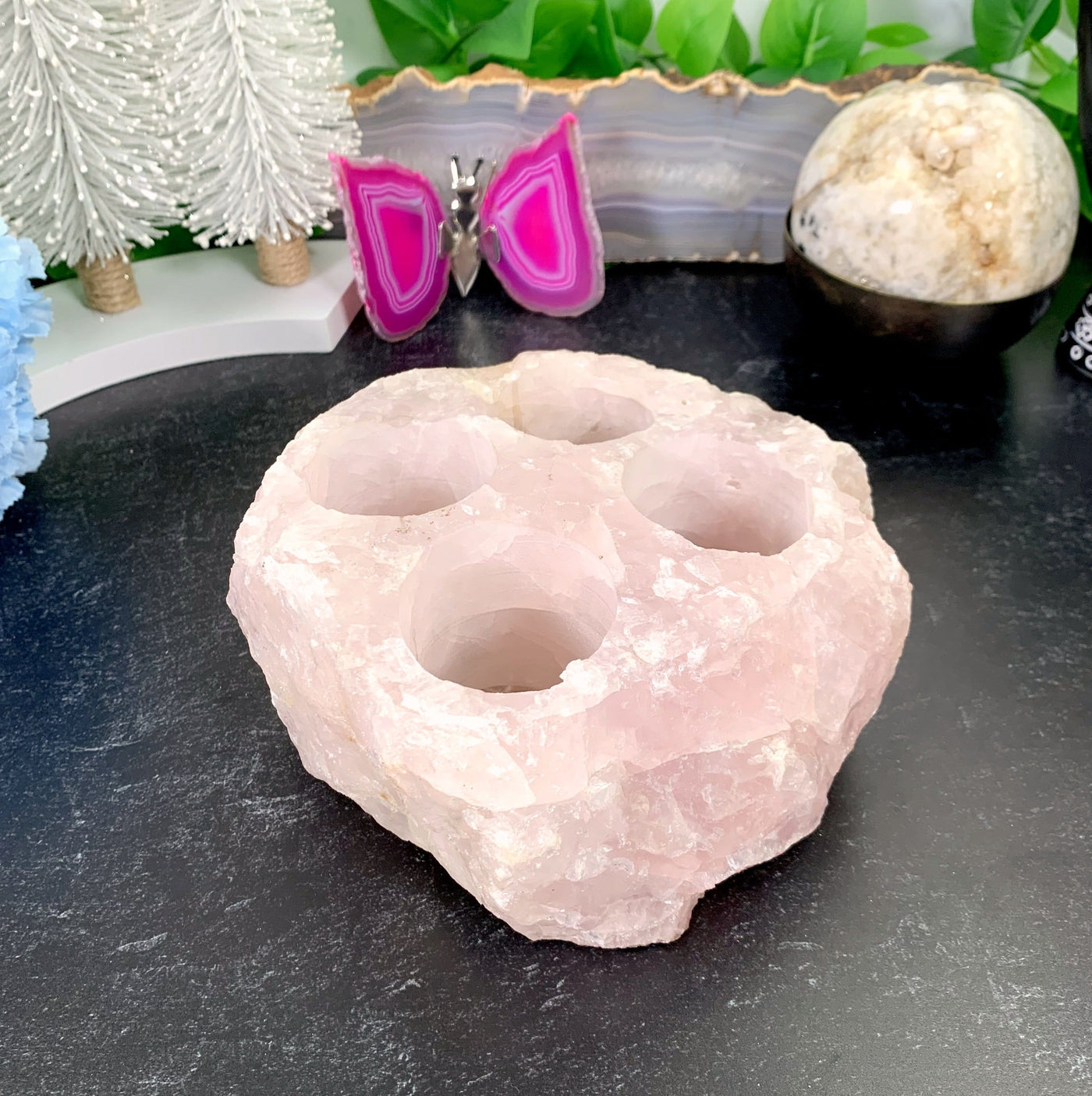 Rose Quartz Candle Holder with various decorations in the background