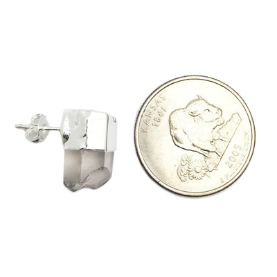 One silver crystal quartz stud earring compared to a quarter on a white background.  It is slightly smaller than the quarter.
