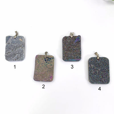 4 variations of Rainbow Titanium Druzy Pendants on white background