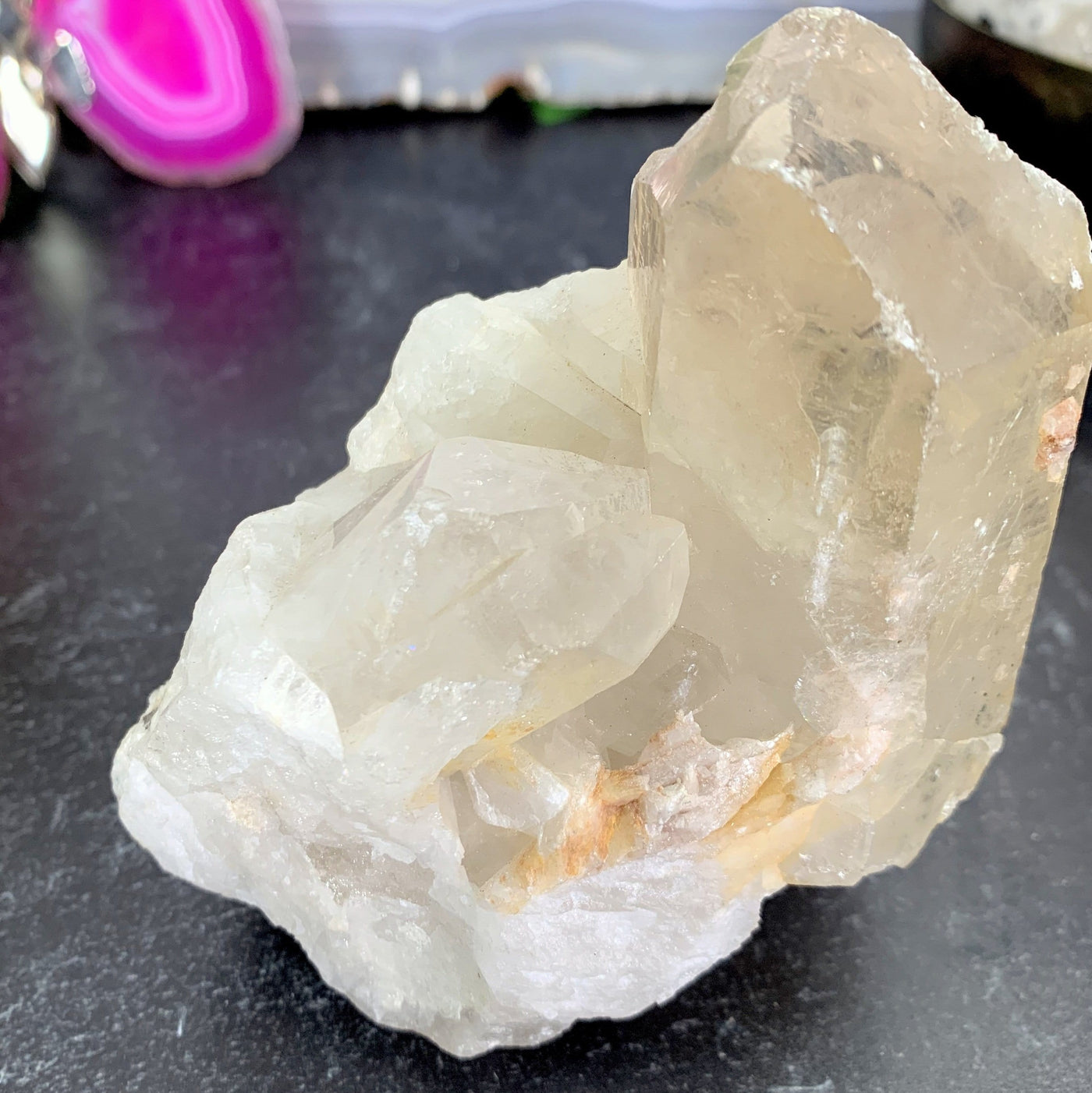A side view of the one of a kind piece of a tangerine quartz cluster that Measurements Approximately: 3.5"L x 2.65"W x 3.5"H