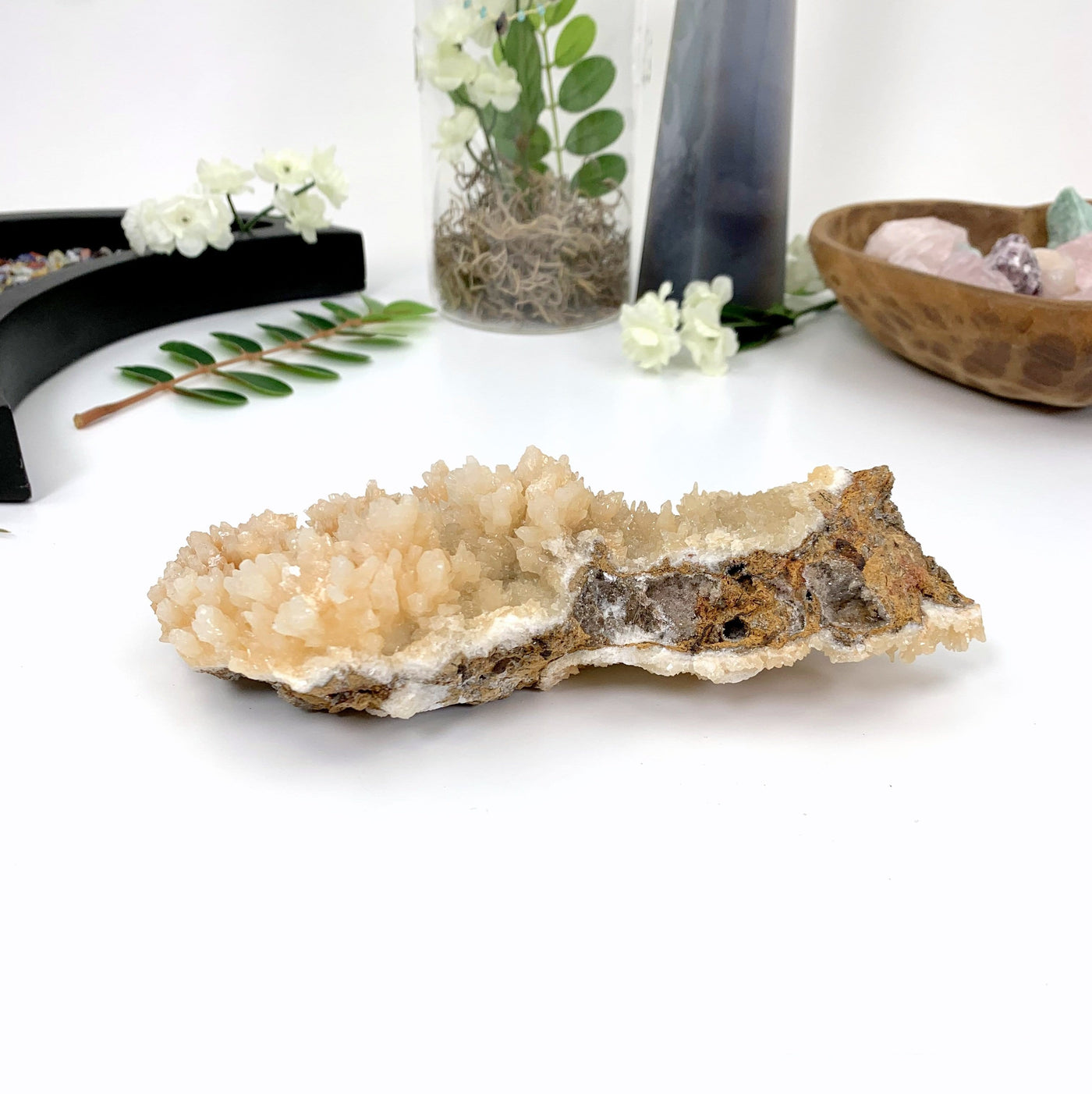 back view of calcite druzy cluster on a white background