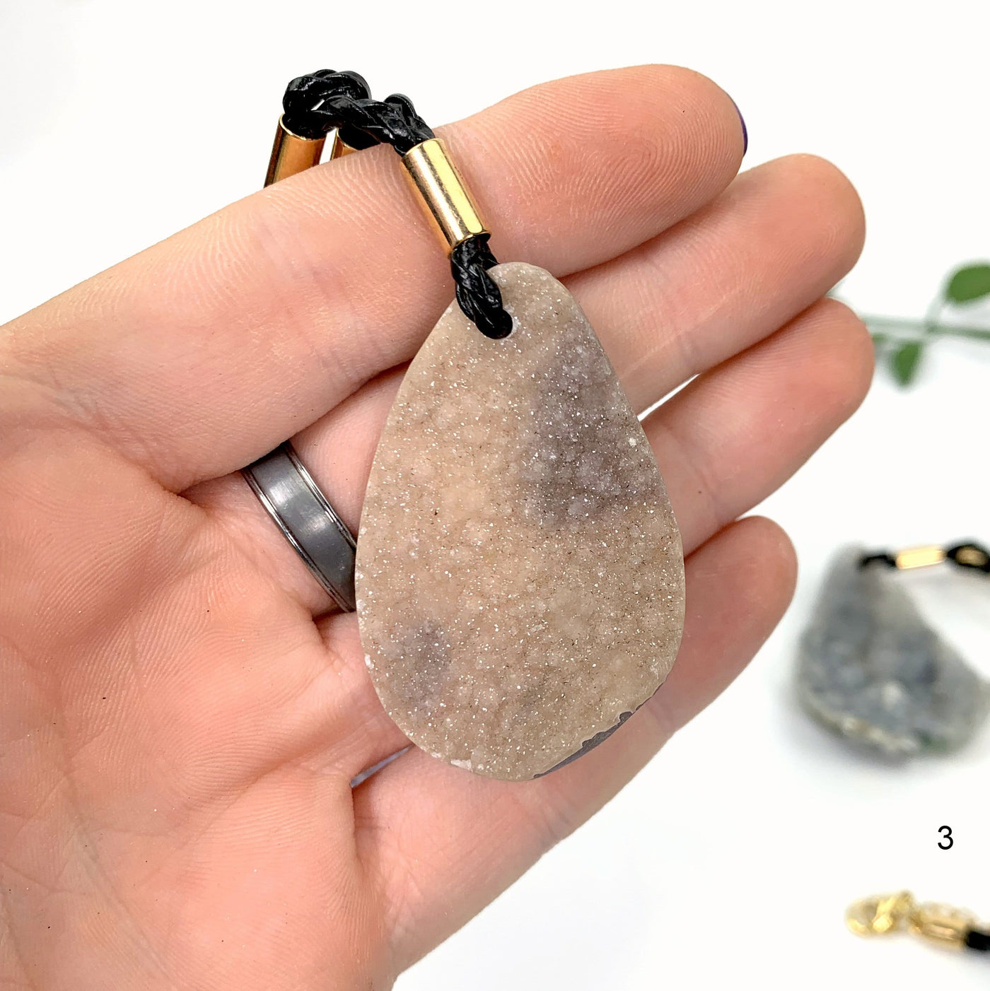 hand holding up Druzy Teardrop Shaped Necklace 