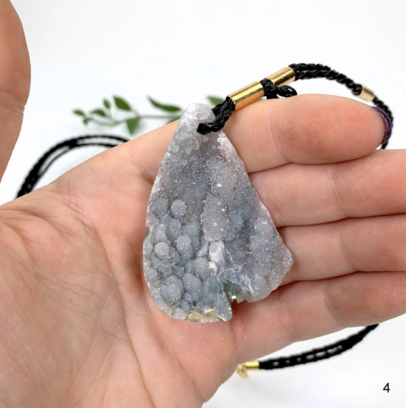 hand holding up Druzy Teardrop Shaped Necklace