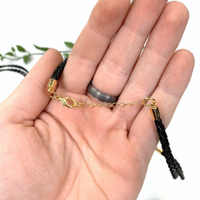 hand holding up necklace chain to show clasp