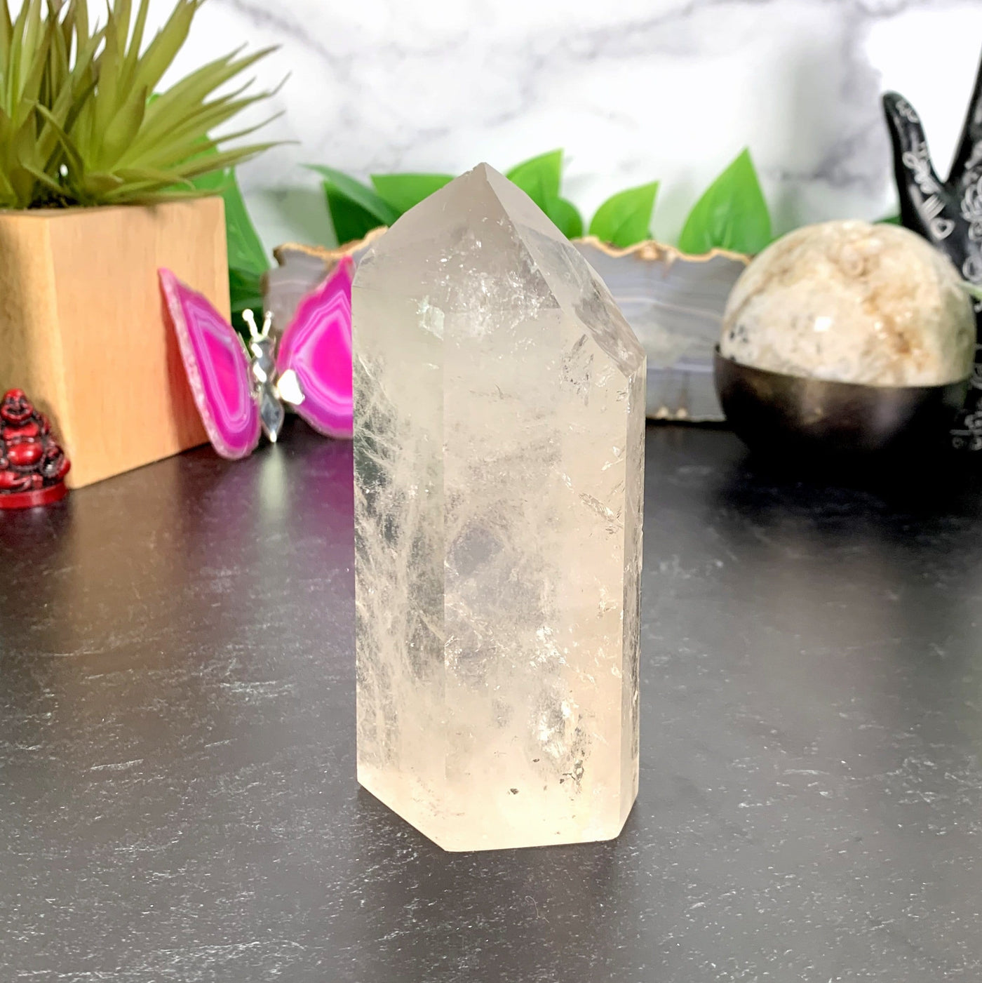 Crystal Quartz Tower Point with decorations in the background