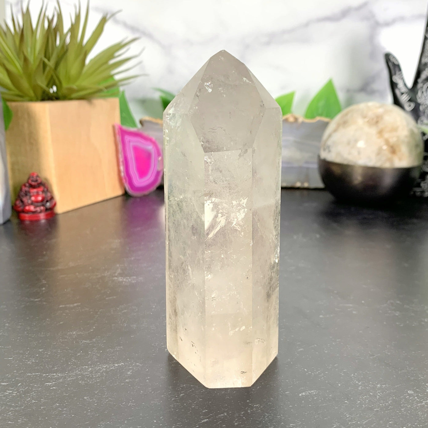 Crystal Quartz Tower Point with decorations in the background