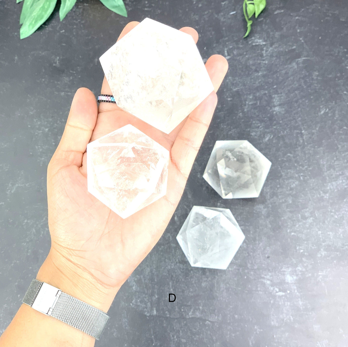 Hand holding option D a small and large Crystal Quartz Icosahedron