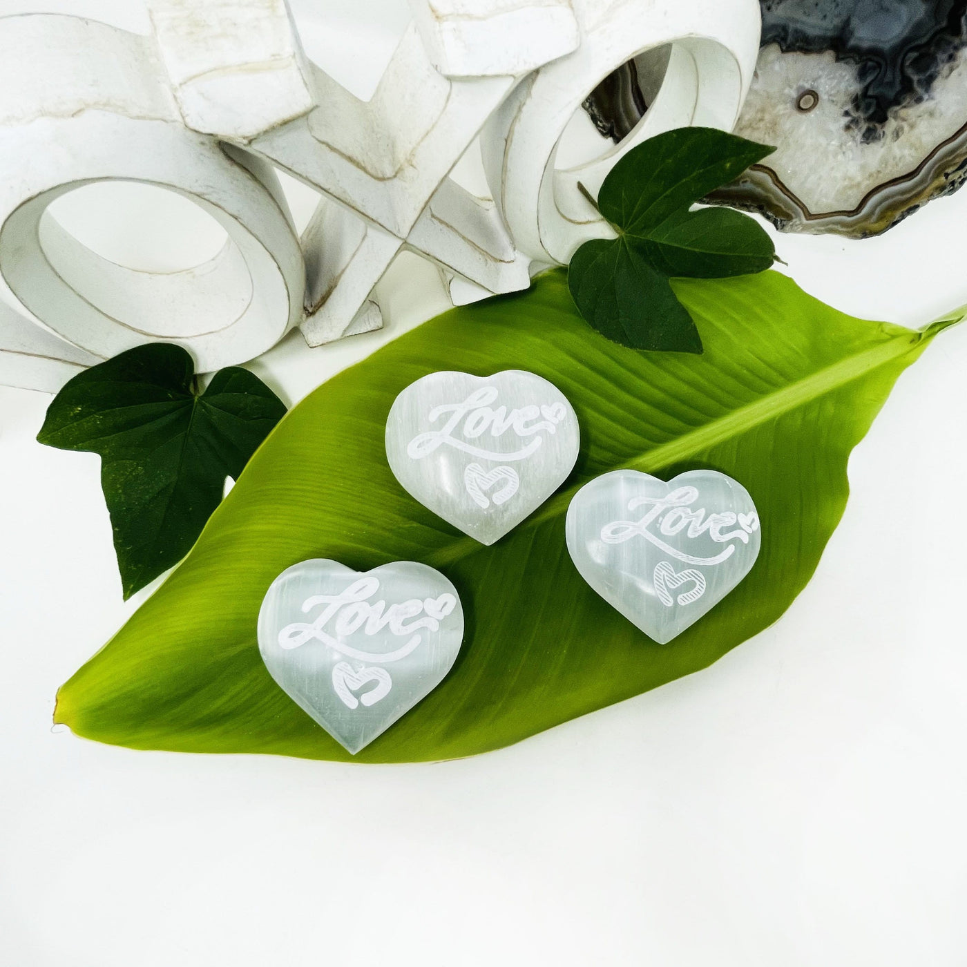 selenite engraved "love" heart stones on display