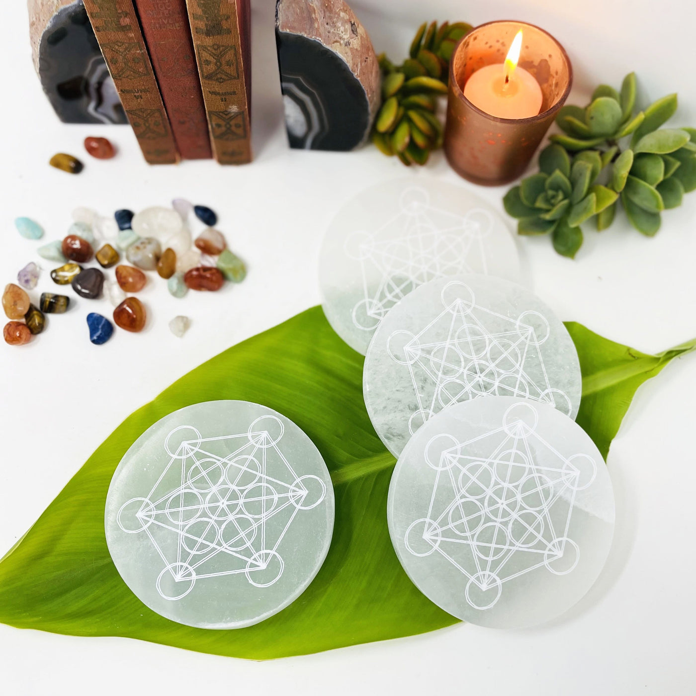 selenite rounds with metatron engraving on display
