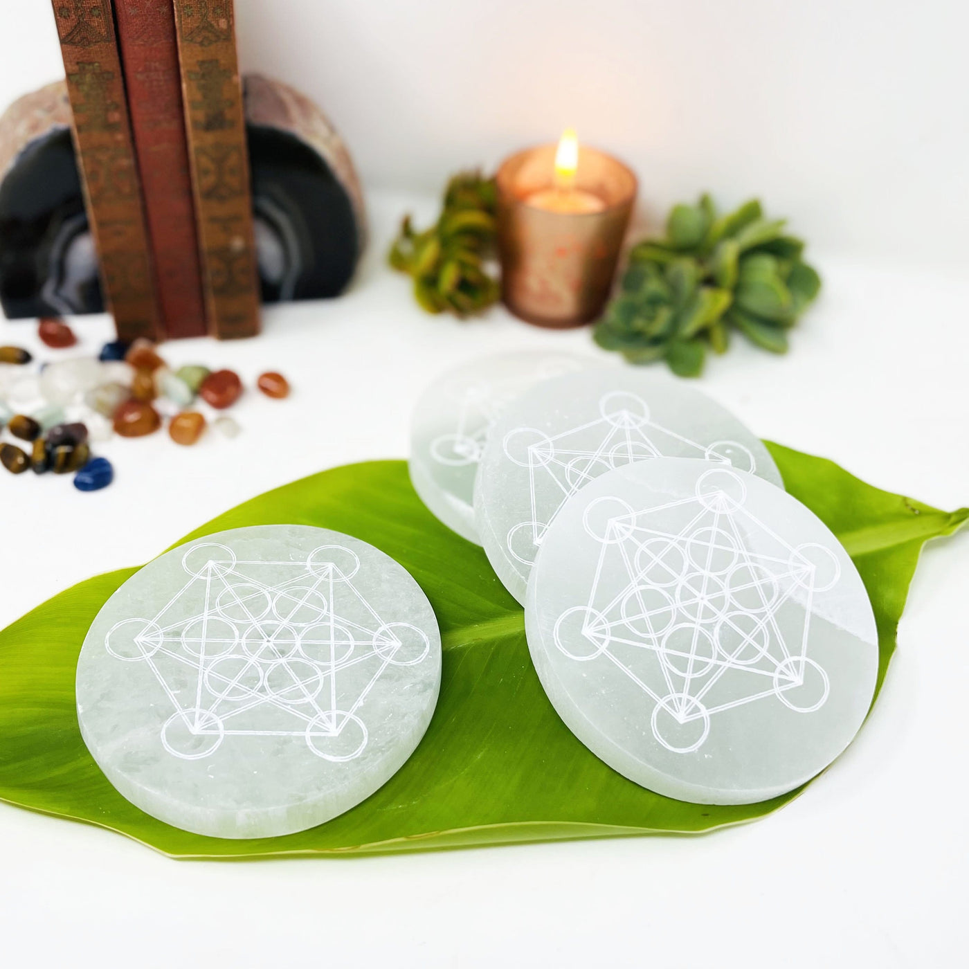 selenite rounds with metatron engraving on display