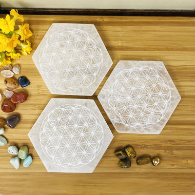 overhead view of selenite hexagons engraved with flower of life for engraving details