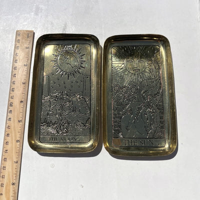 brass trays next to a ruler for size reference 