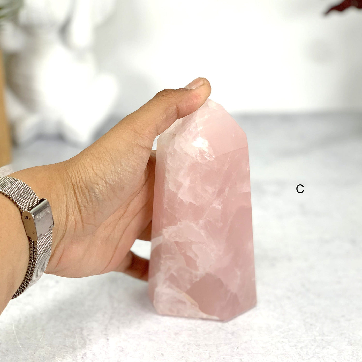 Hand comparing size to Option C - Rose Quartz Semi Polished Points Tower