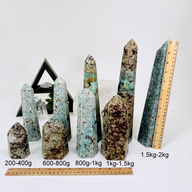 amazonite towers displayed next to a ruler for size reference. points available in 200-400 grams, 600-800 grams, 800 grams - 1 kilograms, 1 kilograms- 1.5 kilograms and 1.5 kilograms to 2 kilograms 
