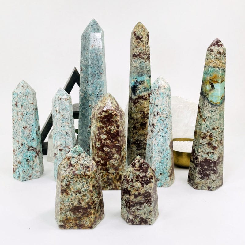 multiple amazonite polished towers displayed to show the differences in the sizes and color shades 