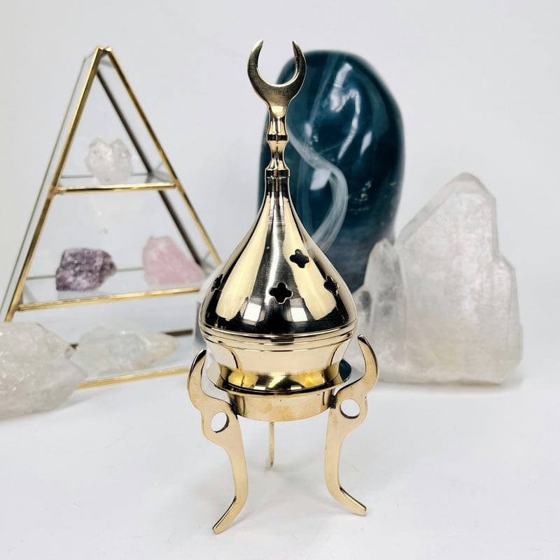 brass cone or resin burner set up as home decor 
