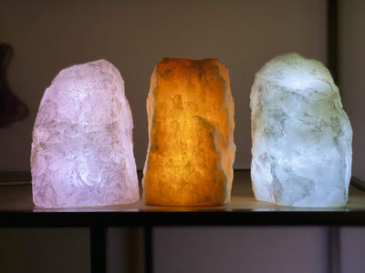 3 Rough Stone Lamps lit up in dark room