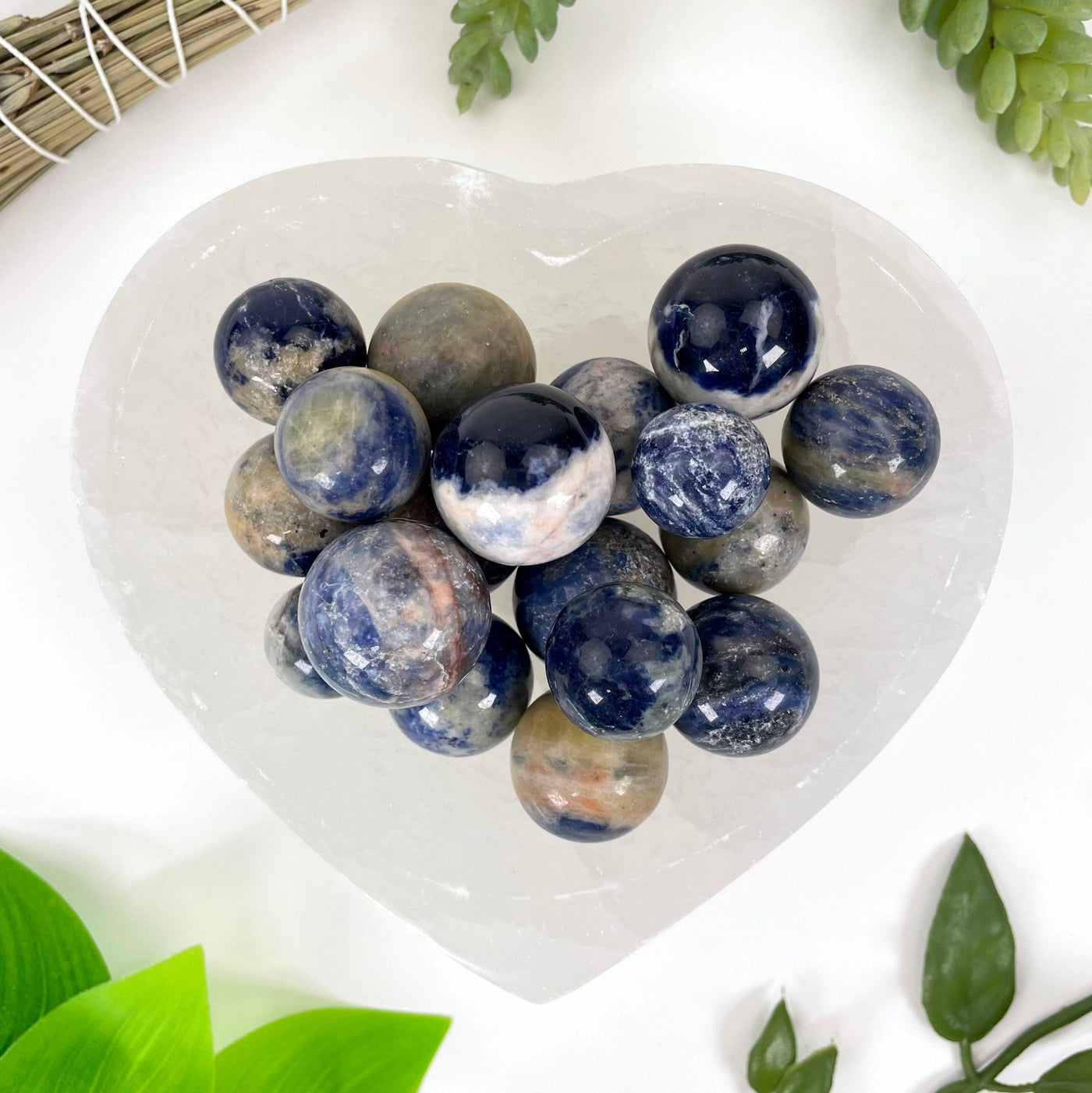 close up of many sodalite sphere balls in a heart bowl for details and possible variations