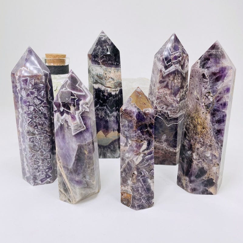 multiple chevron amethyst polished towers displayed to show the differences in the sizes and color shades 