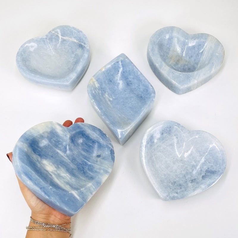 multiple blue calcite bowls displayed to show the differences in the sizes and color shades