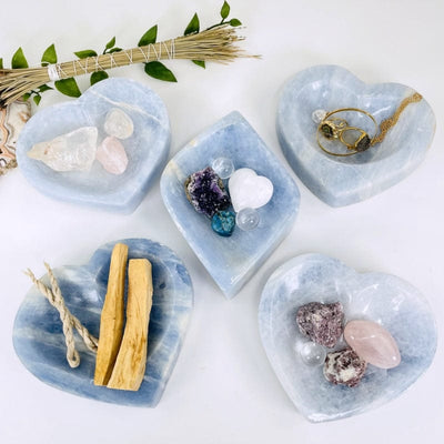 multiple blue calcite bowls displayed to show the differences in the sizes and color shades 