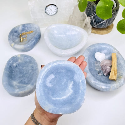 multiple blue calcite bowls displayed to show the differences in the sizes and color shades 