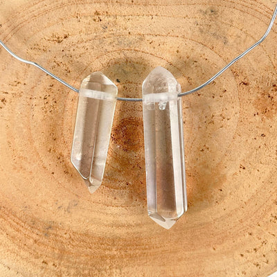 approximate largest and smallest drilled crystal quartz double points with wire strung through