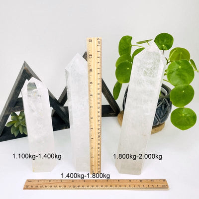 crystal quartz towers next to a ruler for size reference