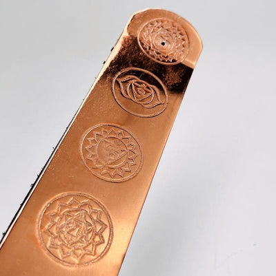 close up of the engraved chakra symbols on the incense burners 