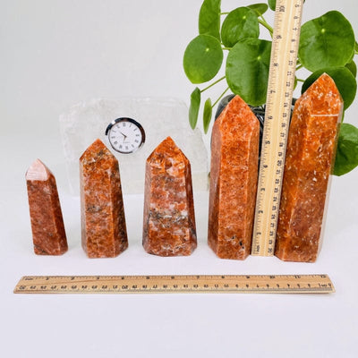 orchid calcite points next to a ruler for size reference 