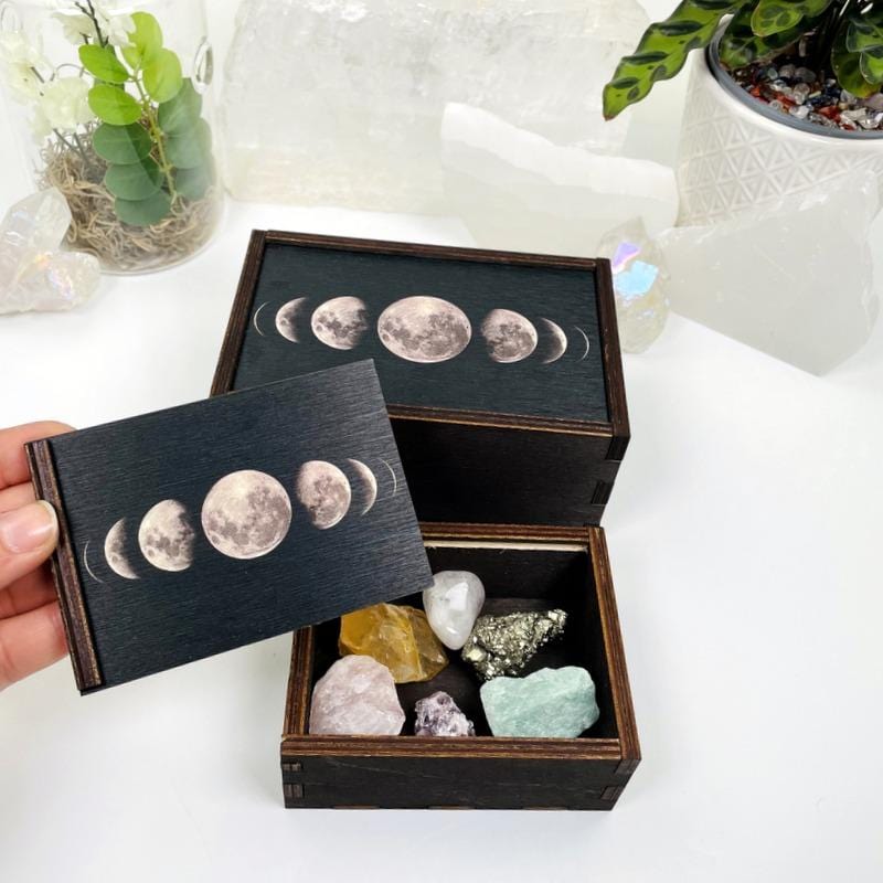 hand holding up lide for Wooden Storage Box with box filled with crystals