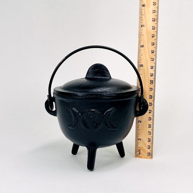 caldron next to a ruler for size reference 