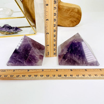 amethyst pyramid next to a ruler for size reference 