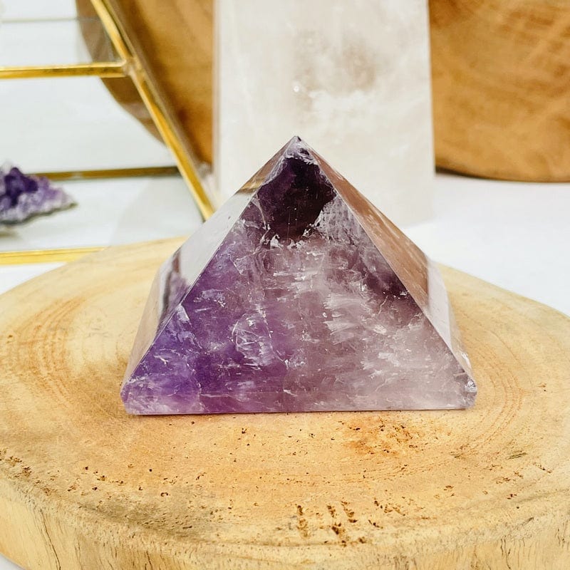 close up of an amethyst pyramid set as home decor 