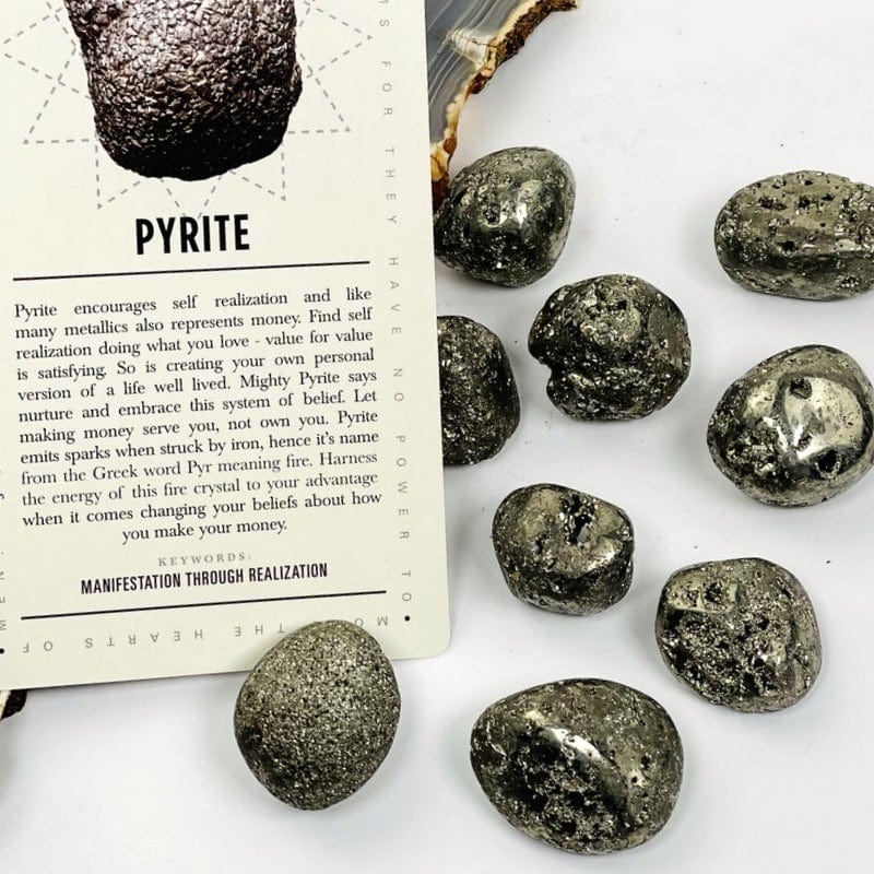 tumbled pyrite stones on white background 