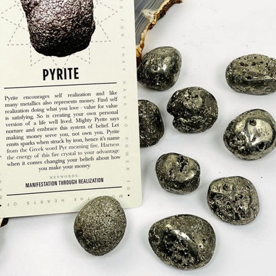 tumbled pyrite stones on white background 