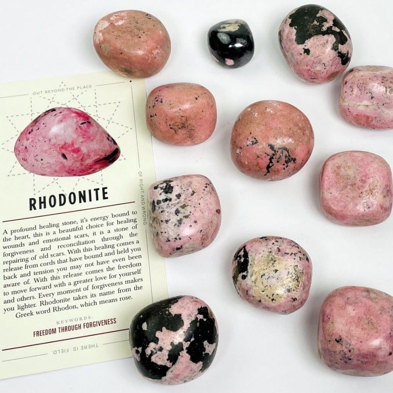 tumbled rhodonite stones on white background 