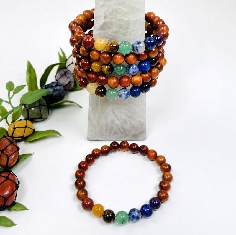 multiple chakra bead bracelets with sandalwood showing both sides of the bracelet