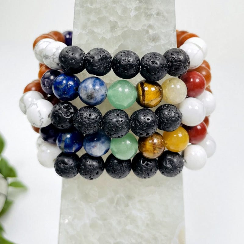 close up of multiple chakra round bead bracelets