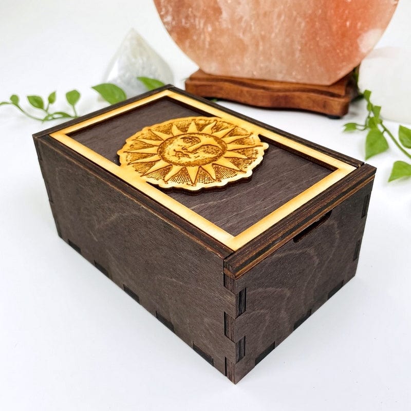 side shot of dark wooden storage box with lid and engraved sun