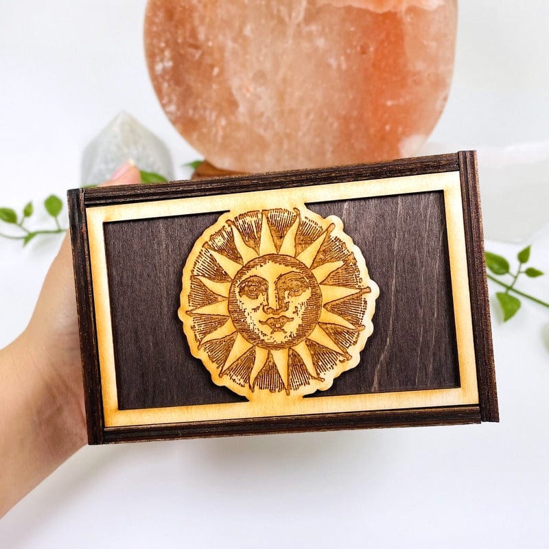 close up of engraved sun on top. box in hand showing the size 