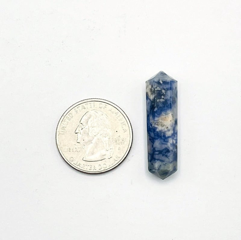 single sodalite double terminated point next to a quarter for size reference. 