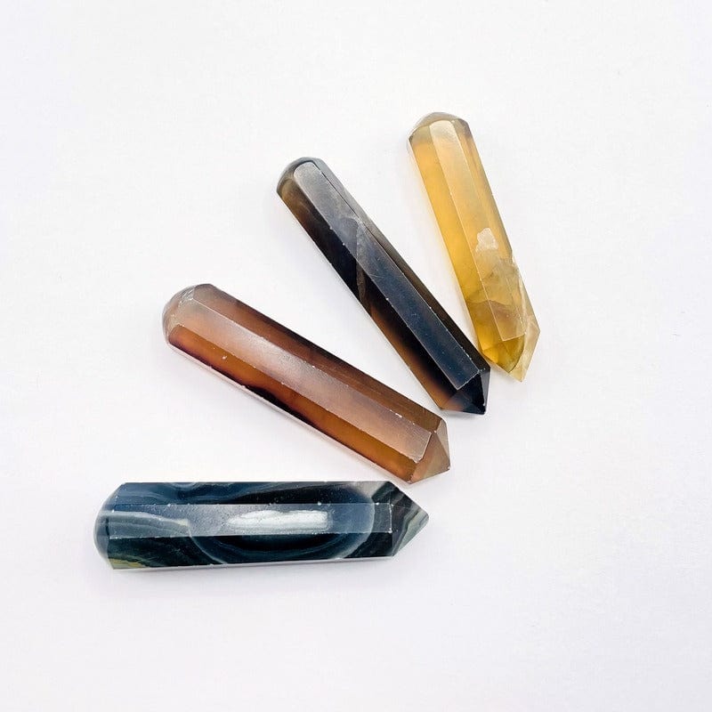 Yellow and green Fluorite massage wands on a table