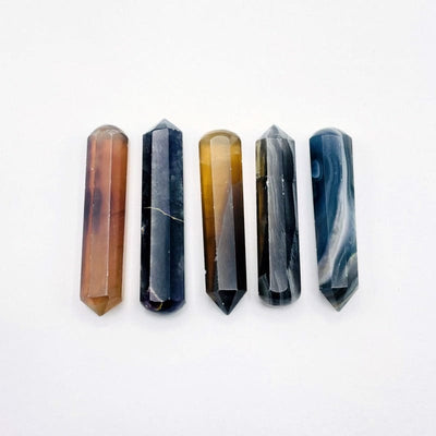 different angle of yellow and green Fluorite massage wands 5 on a table