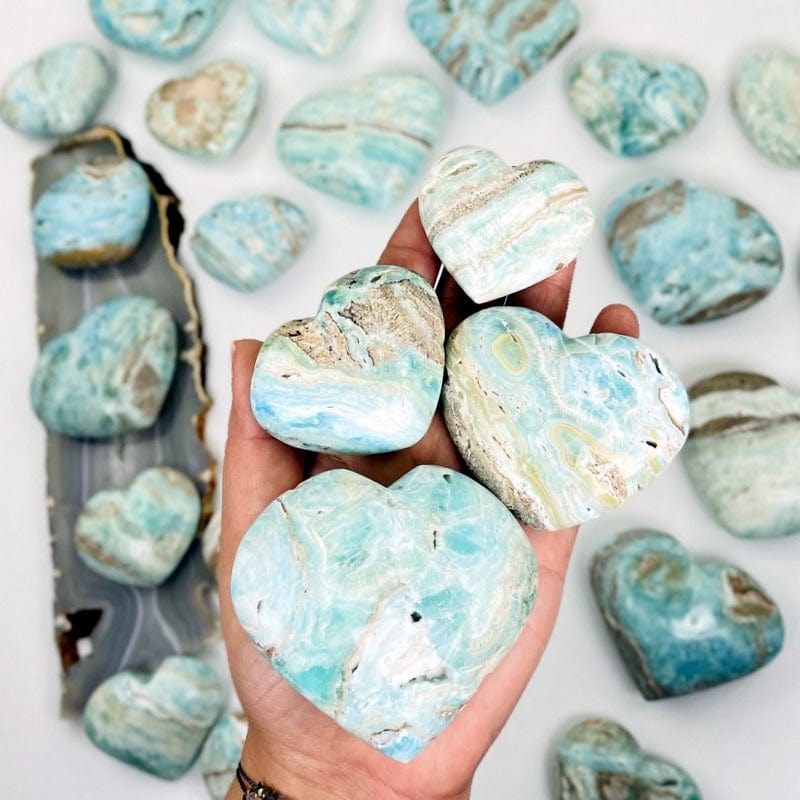 multiple blue aragonite also known as caribbean calcite hearts on hand 