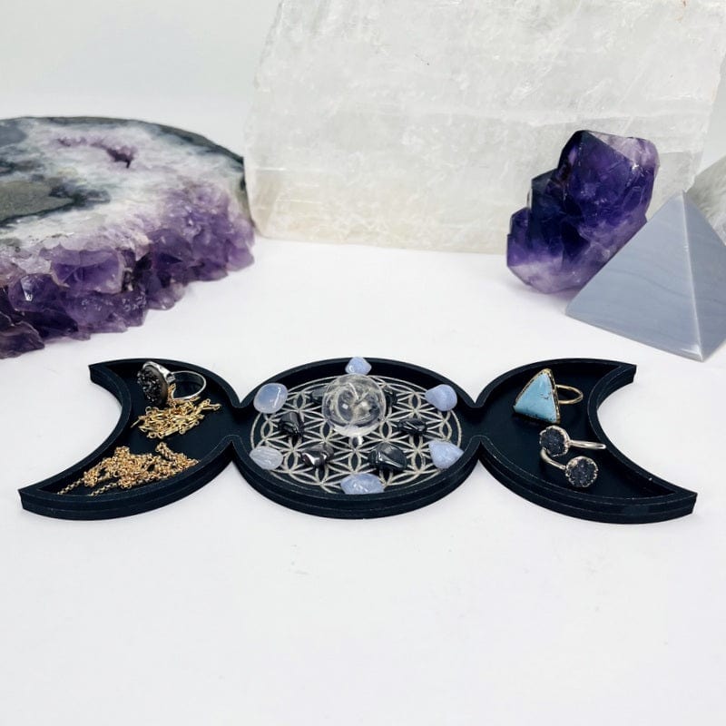 triple moon tray set up as home decor holding jewelry and crystal stones 