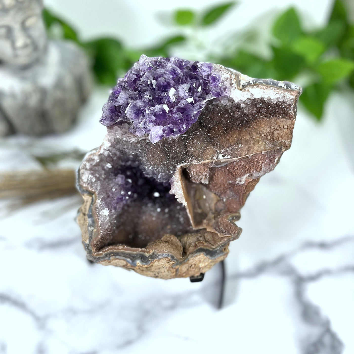 top view of Amethyst Formation on Metal Stand with decorations blurred in the background